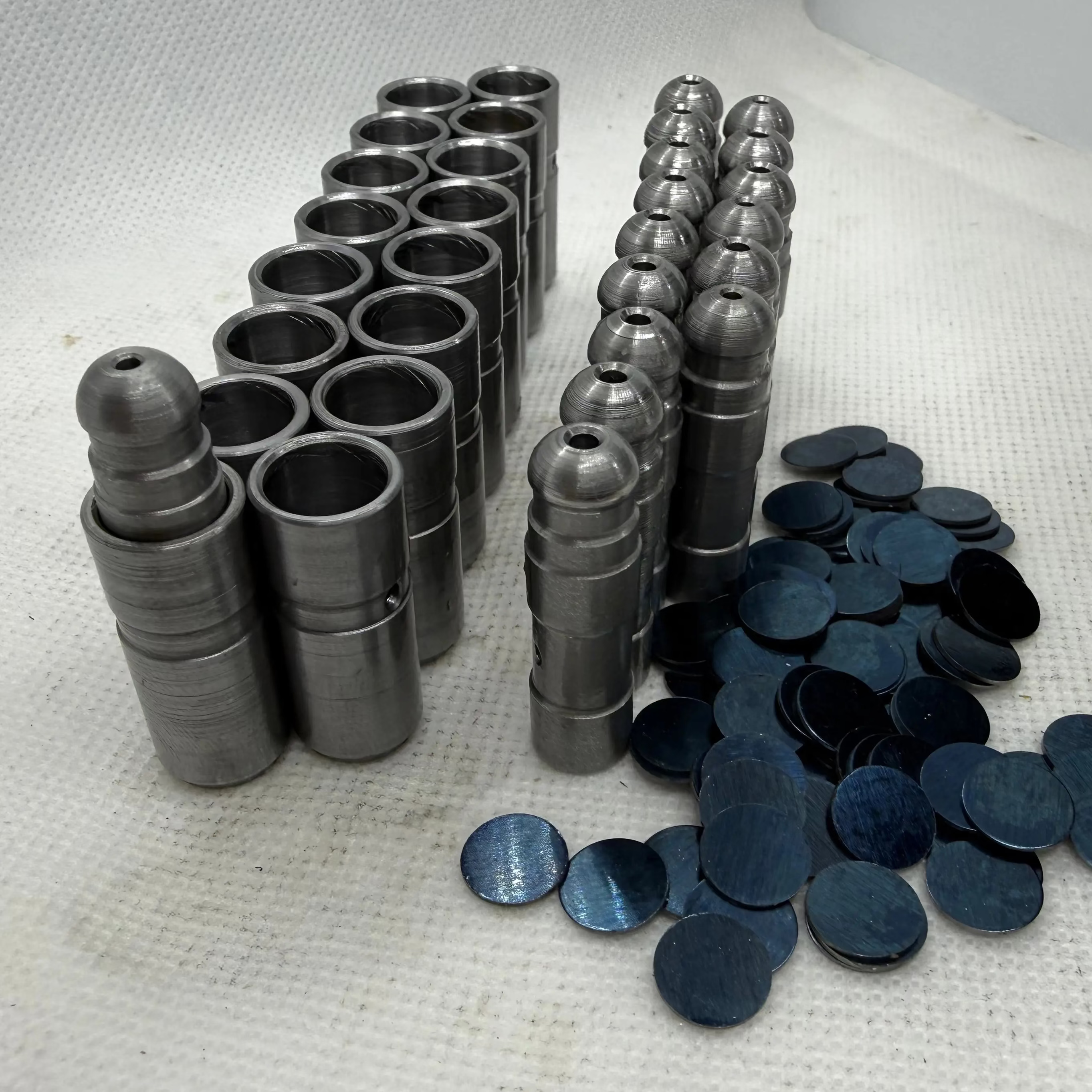 Ecotec solid lash adjusters arranged with adjustment shims